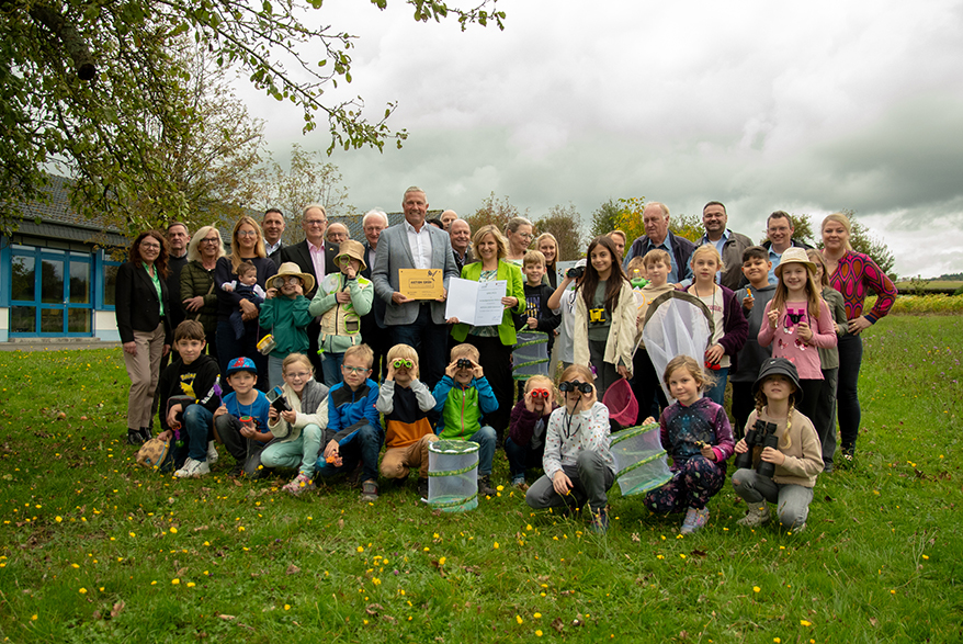 Gruppenbild mit Umweltministerin Katrin Eder und Klaus Lütkefedder, Bürgermeister der VG Wallmerod, vor der Ahrbach-Grundschule in Niederahr, Foto: MKUEM